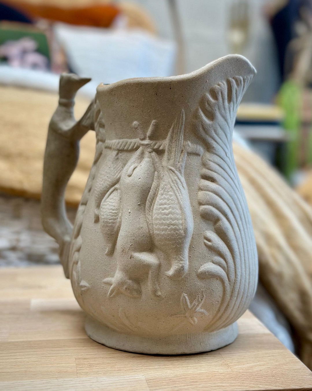 Vintage pottery jug on table