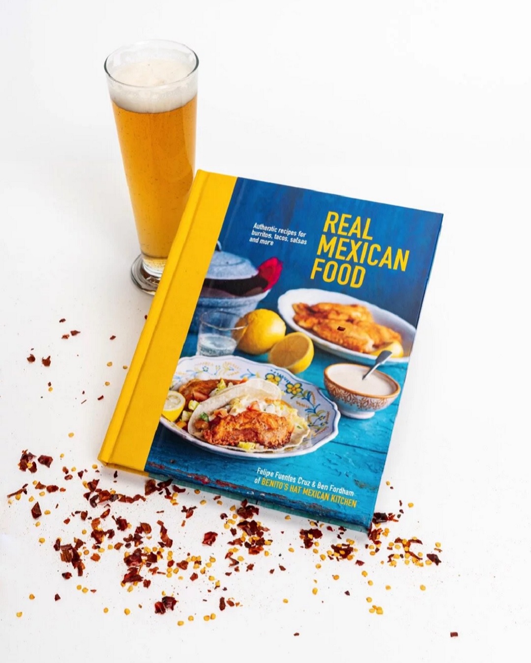 Real Mexican Food cookbook with a glass of beer and chilli flakes