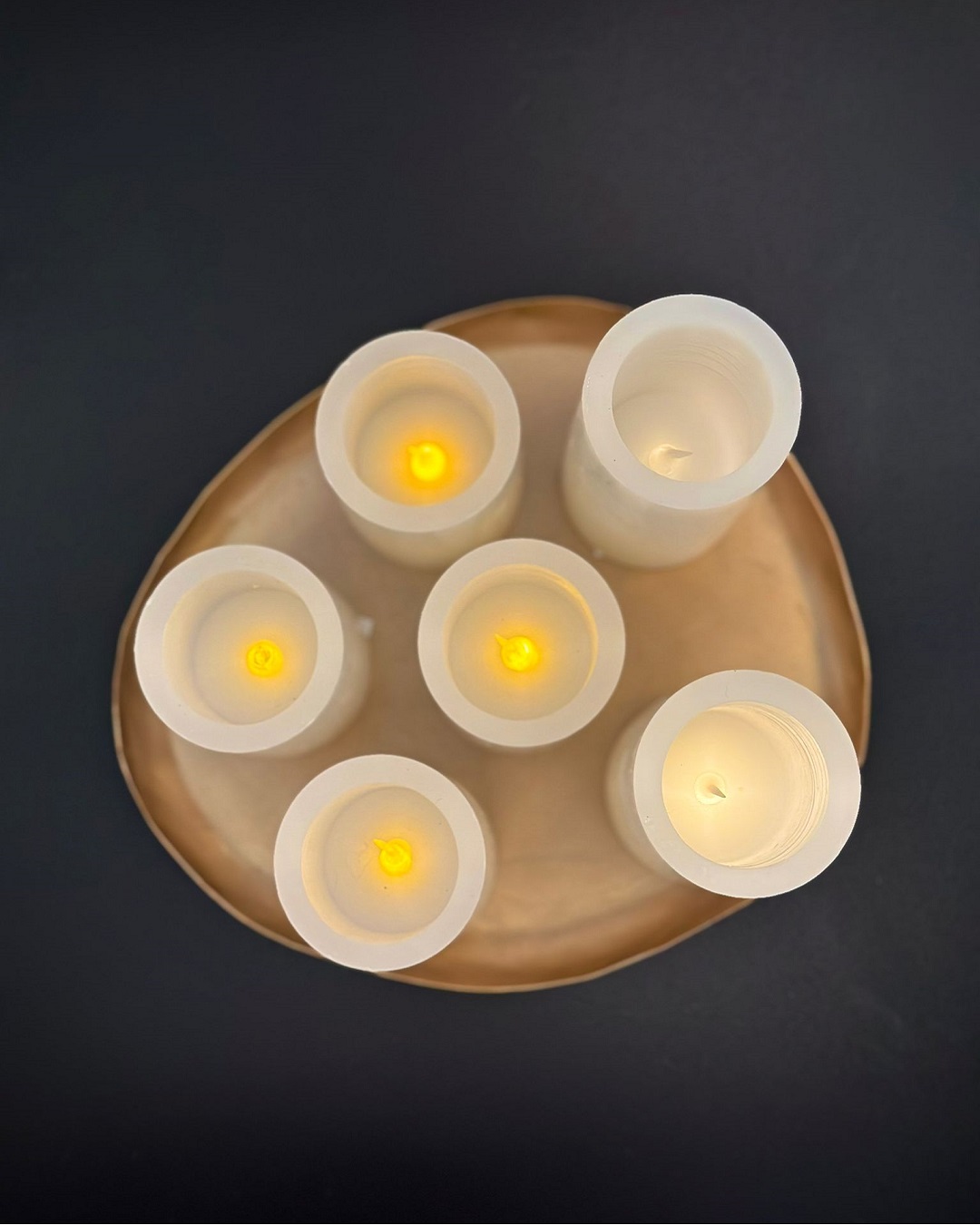 Real Wax LED candles in a dish on table