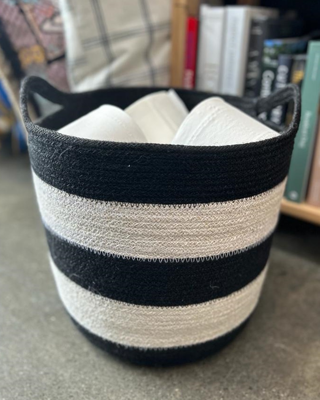 Black and white stripe jute basket with towels inside