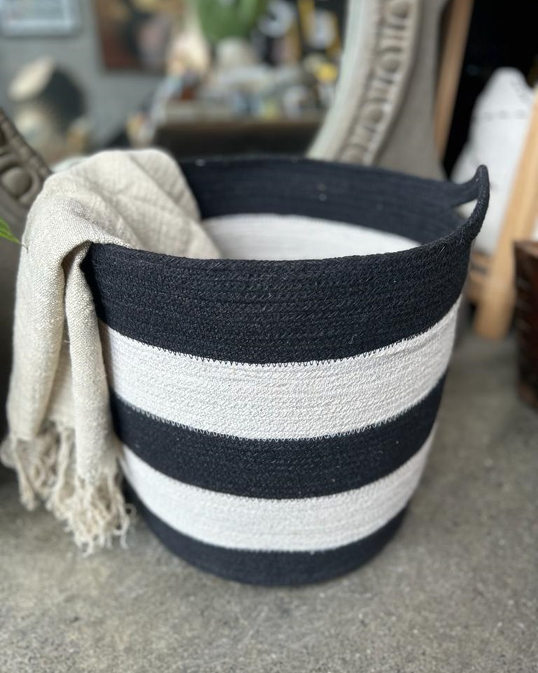 Black and white stripe jute basket with throw inside