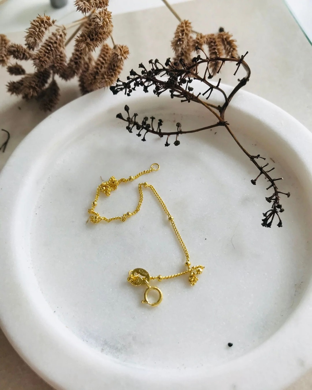 Fine gold chain bracelet on a plate