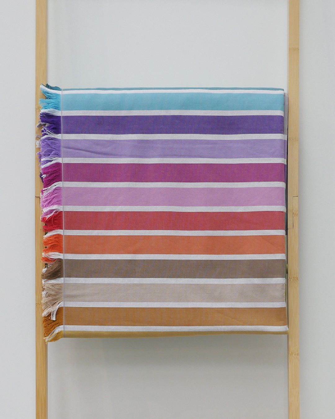 Colourful beach towel hanging on rack