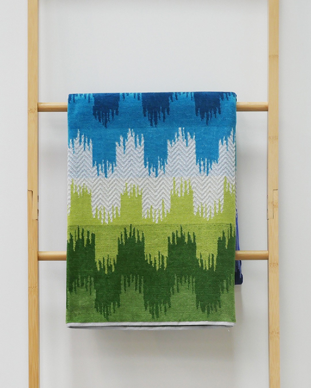 Colourful beach towel hanging on rack
