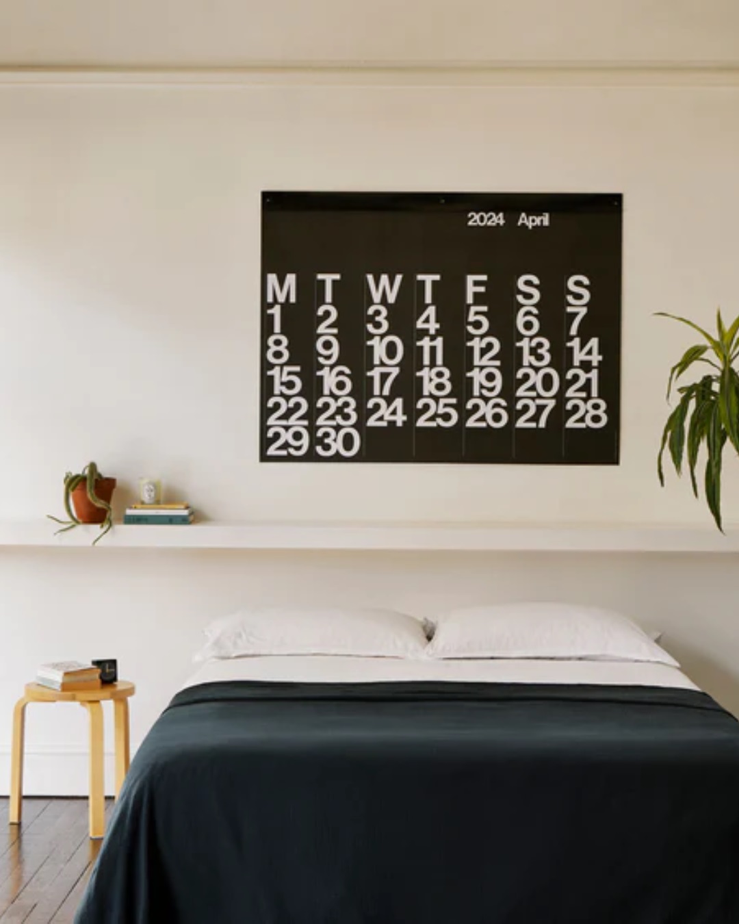Black stendig calendar on bedroom wall