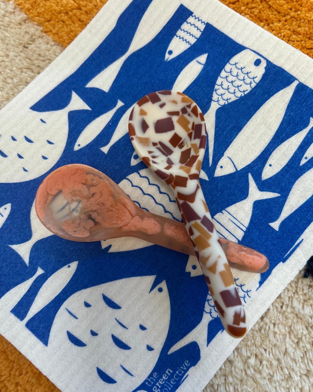 Terrazzo and orange spoons on blue cloth