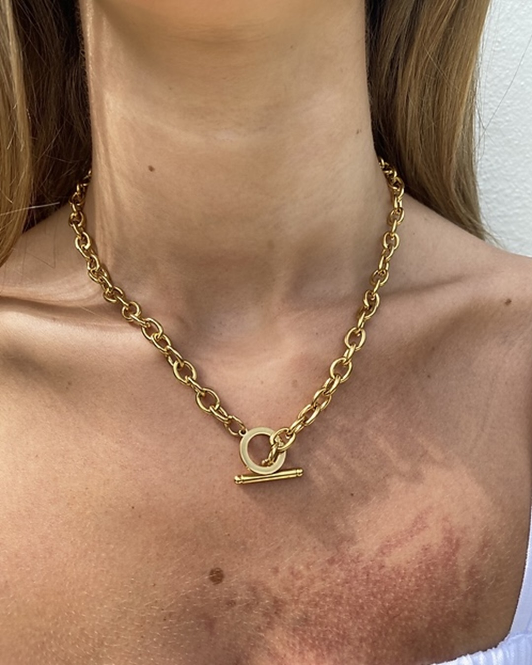 Gold chain necklace on neck