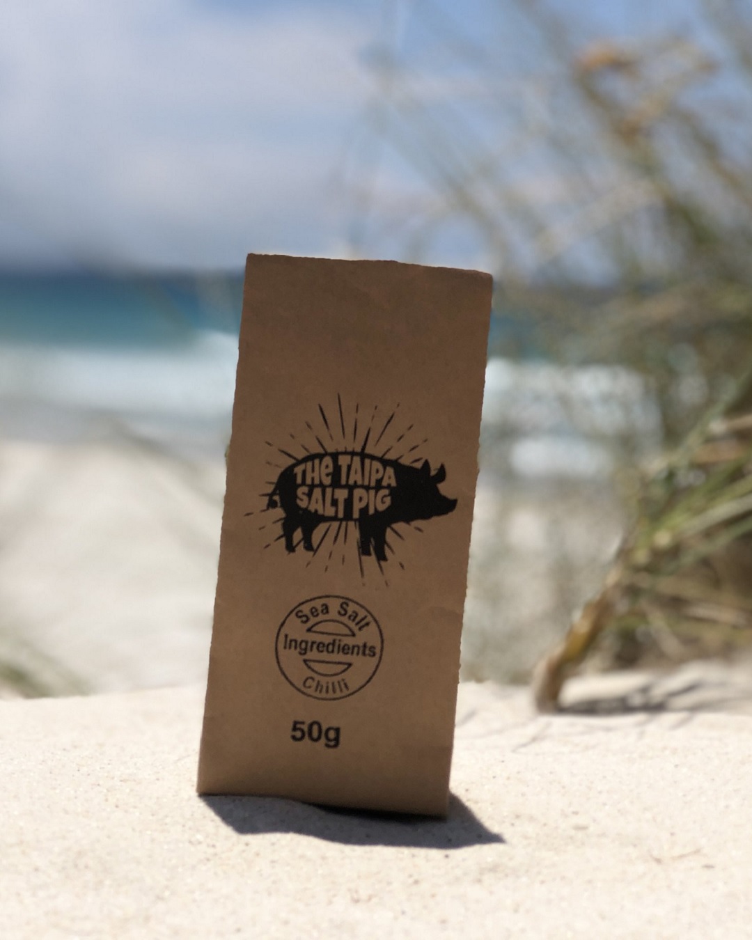 50g bag of Taipa pig chilli salt on sand on the beach