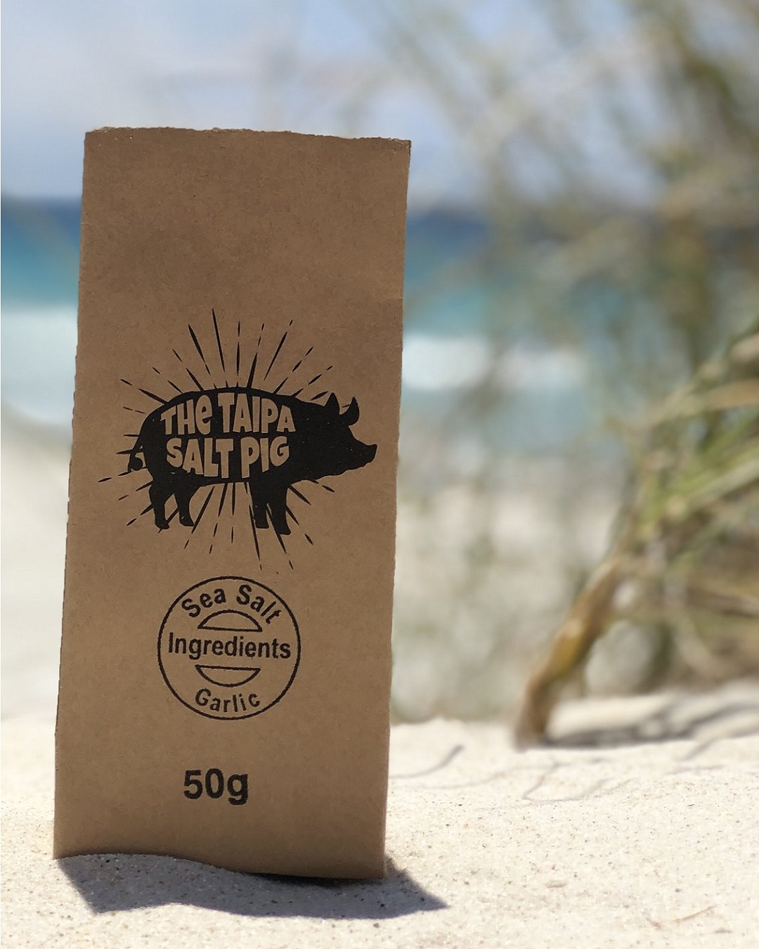 50g bag of Taipa pig garlic salt on sand on the beach