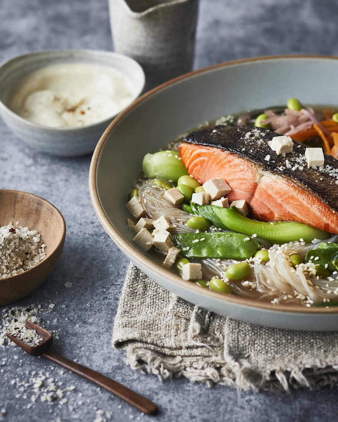 Salmon and fish dish with bowl of salt on side