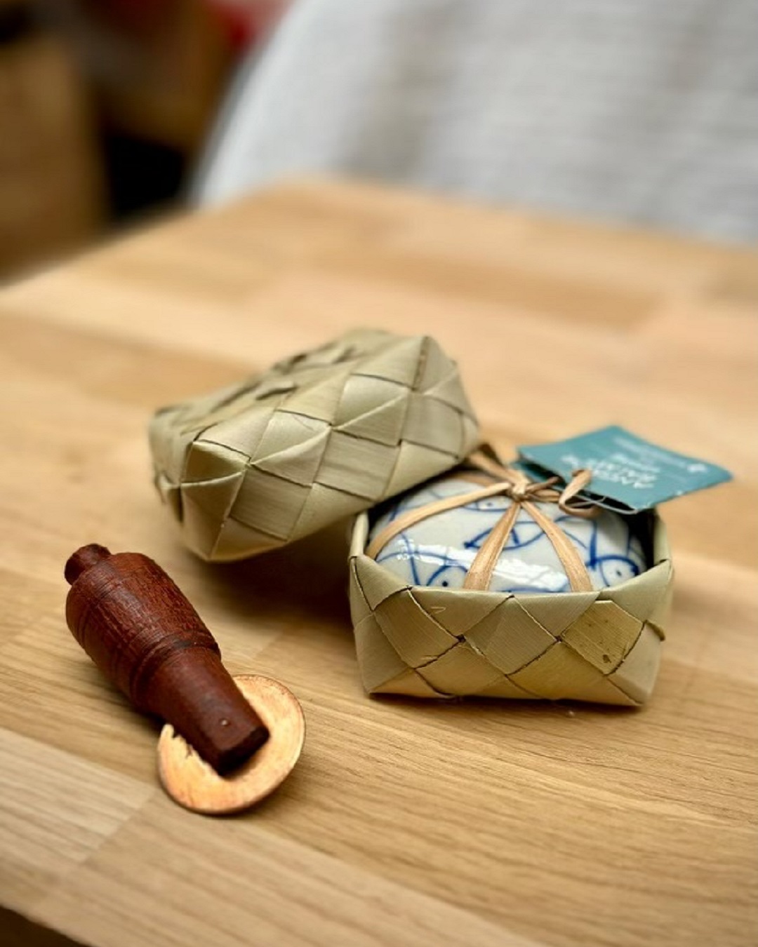 Tiger balm with wooden tool and weaved flax basket on wooden table