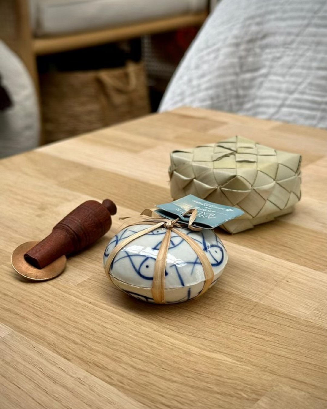 Tiger balm with wooden tool and weaved flax basket on wooden table