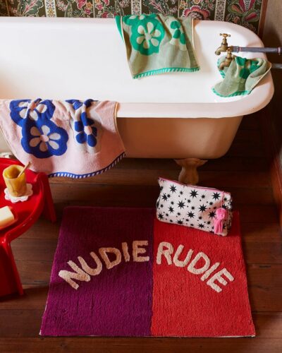 Tula-Nudie-Rudie-Bath-Mat-Poppy-2.jpg Red and orange Nudie Rudie Bath Mat on bathroom floor