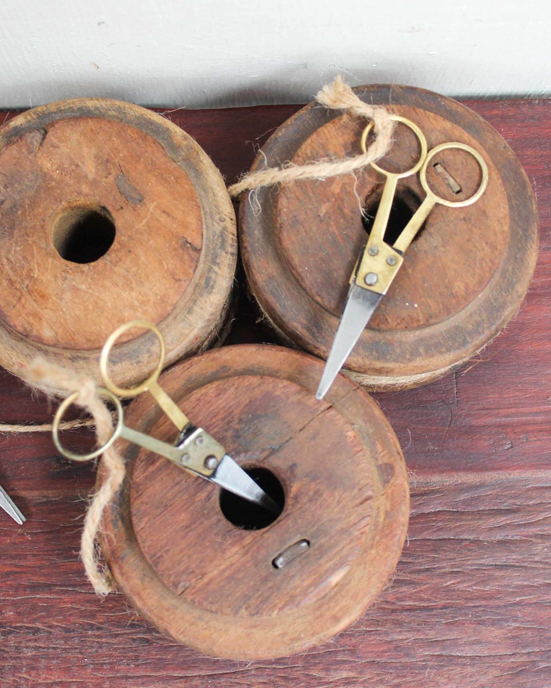 Vintage wooden bobbin with string and scissors