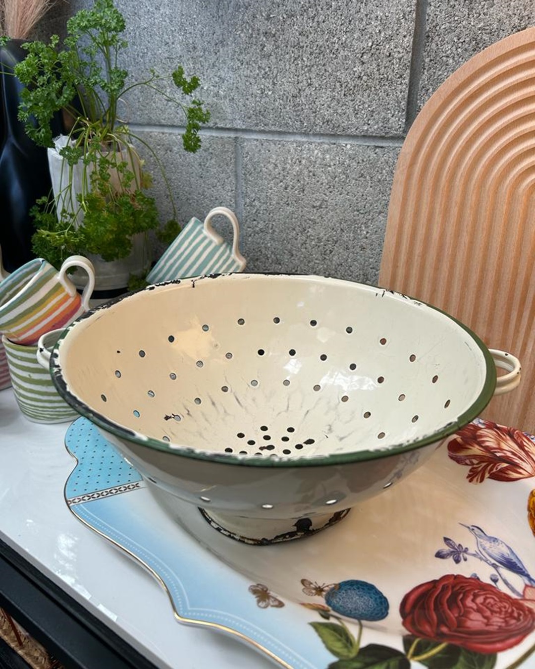 Vintage enamel colander on shelf