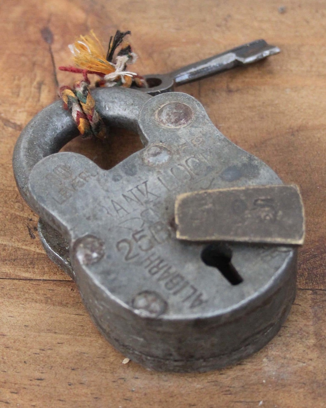 Vintage railway padlock on table