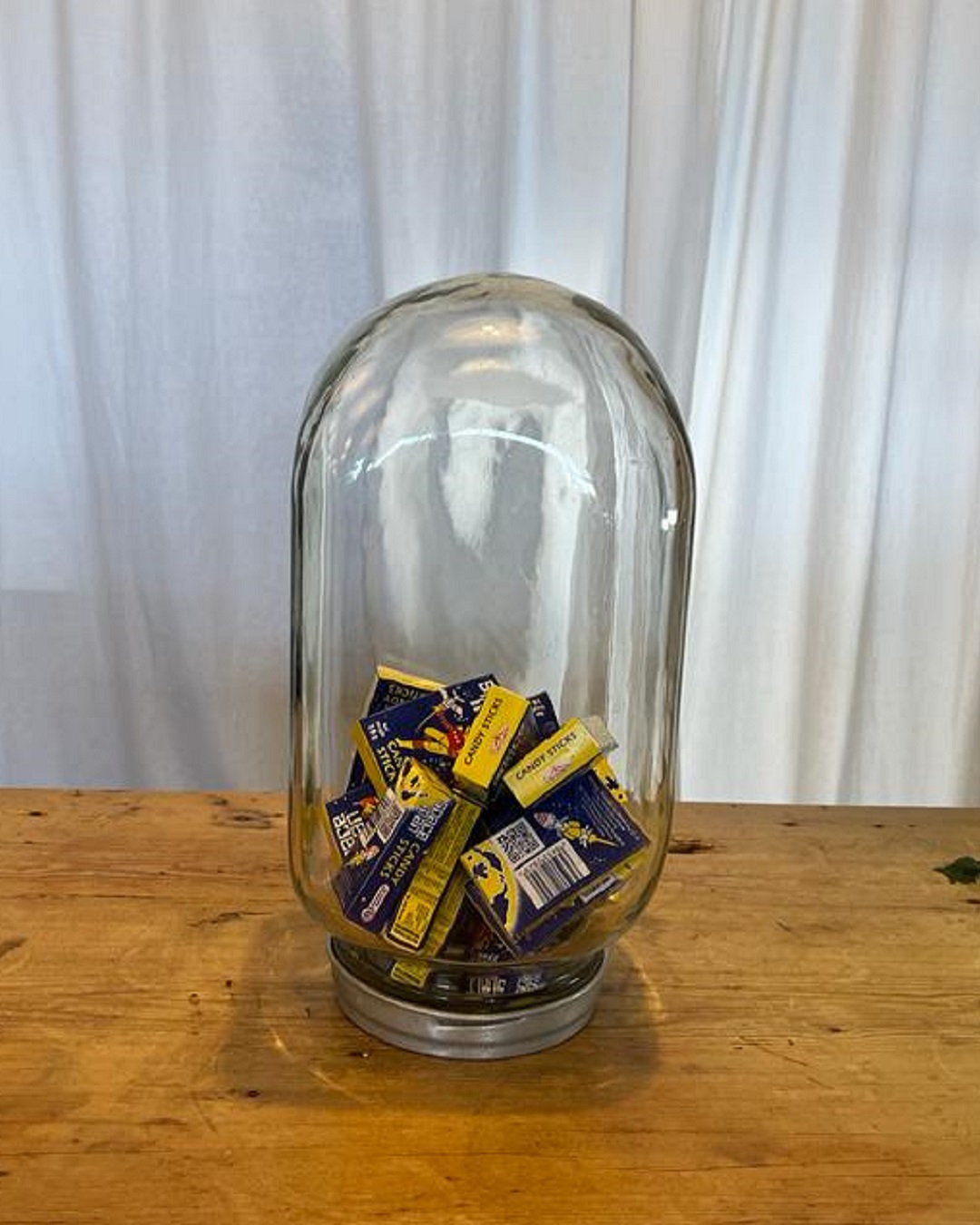 Vintage glass jar with lid and lollies inside