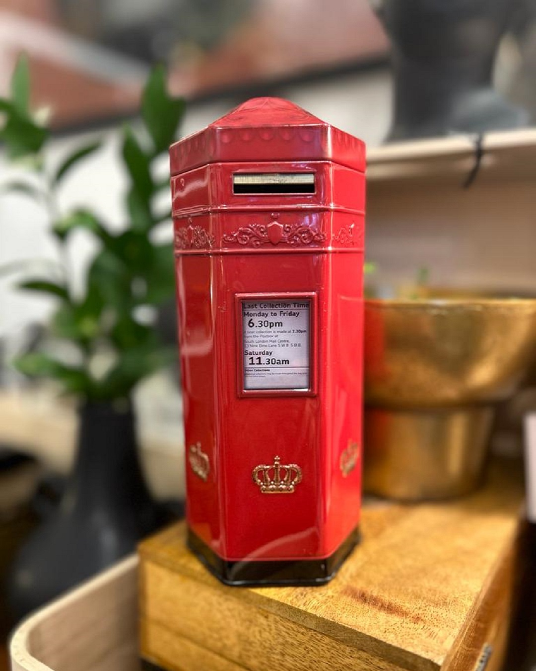 Red money box in shape of an old post box