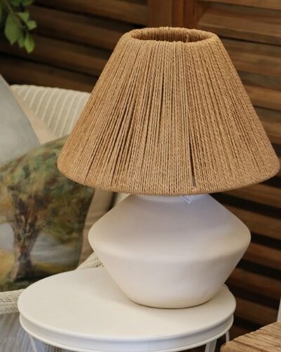 White lamp with loom shade on table