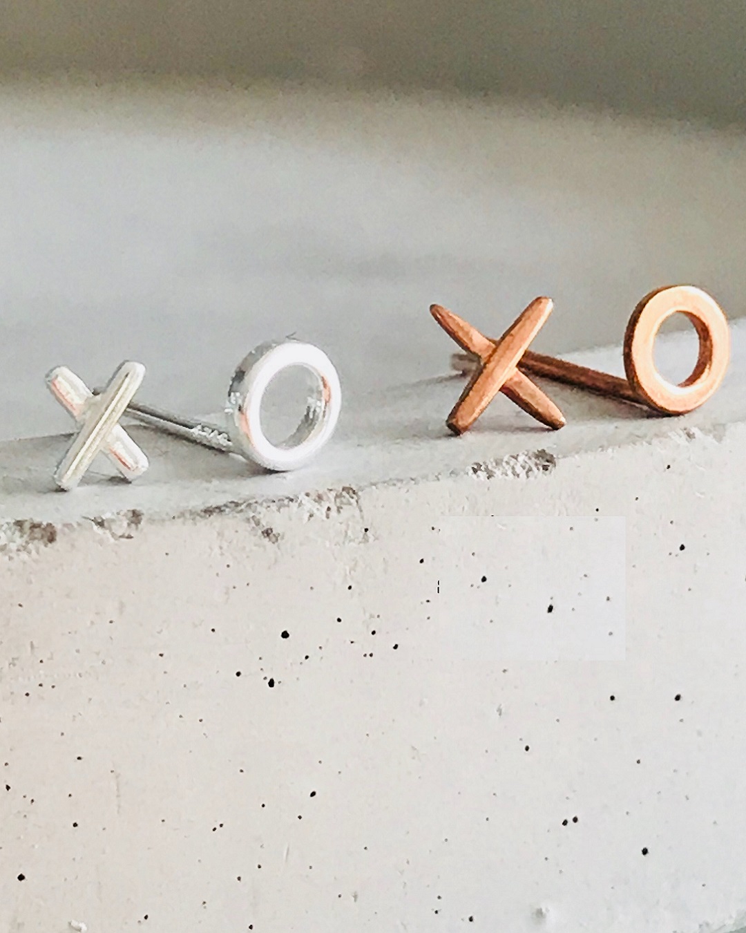 XO stud earrings in silver and rose gold