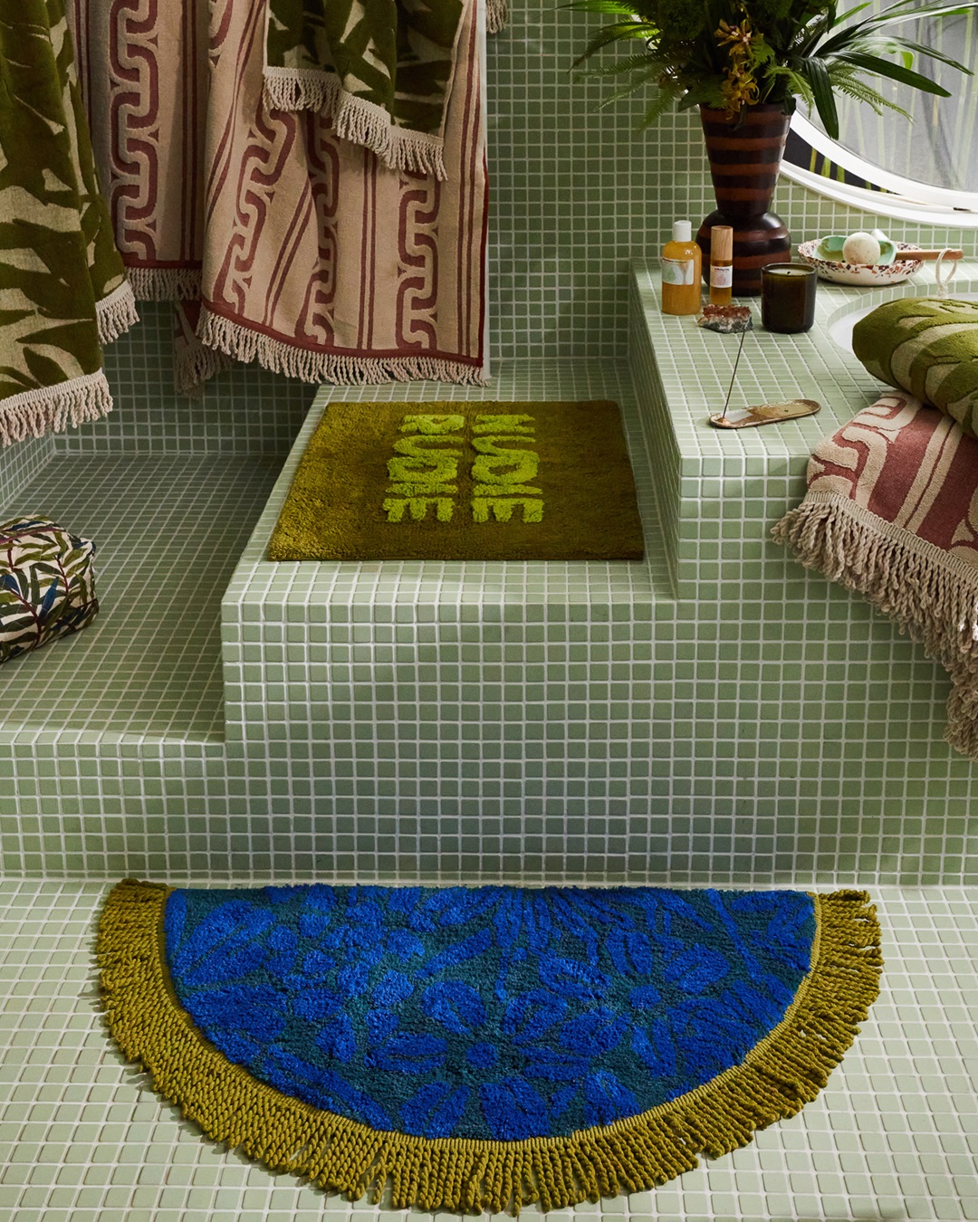 Blue and gold bath mat on tiled bathroom floor