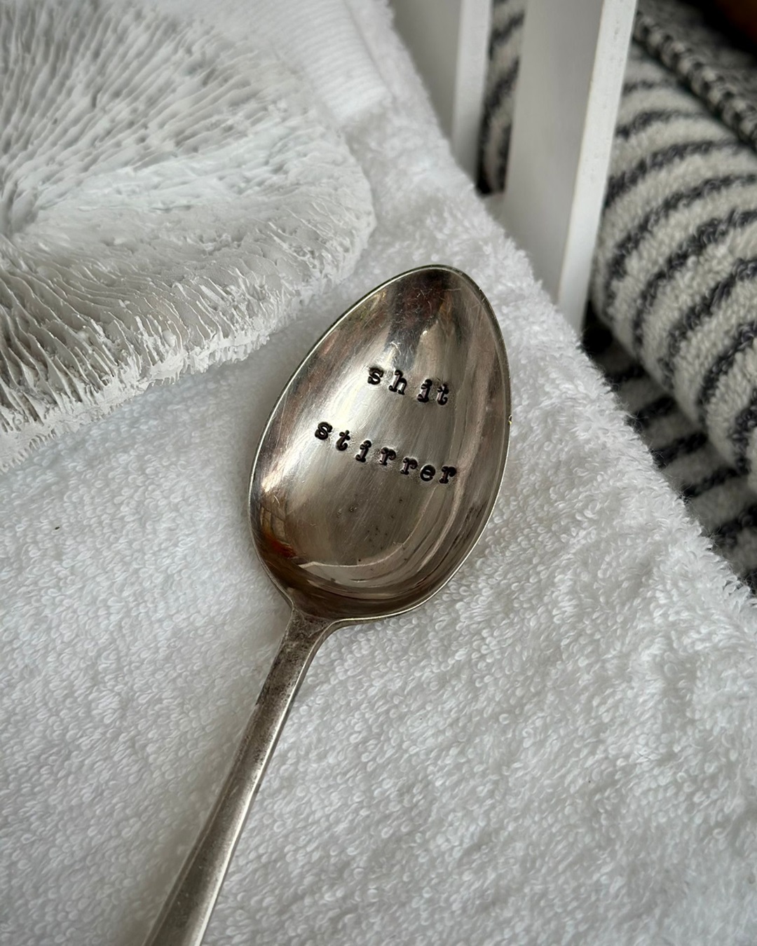 Silver spoon stamped shit stirrer